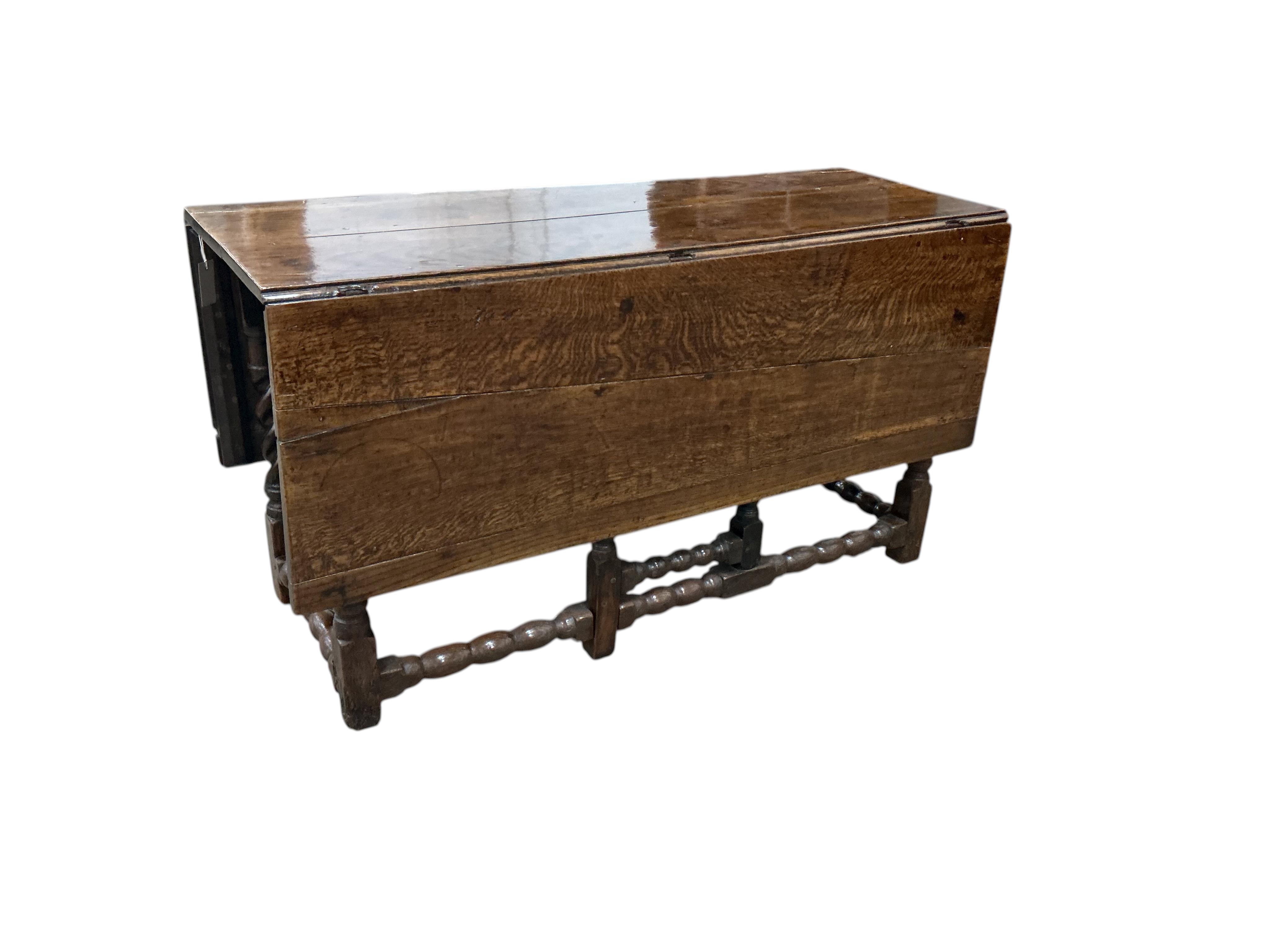 A late 17th / early 18th century oak gateleg table with barley twist legs, width 134cm, length 140cm extended, height 73cm